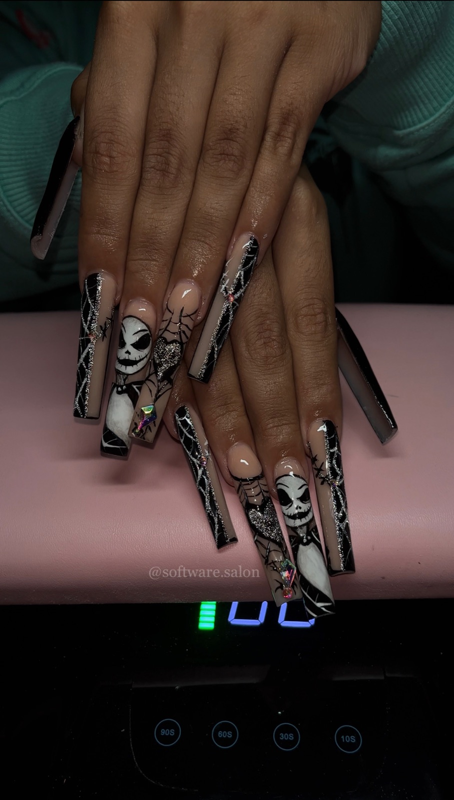 Long black and nude nail set with detailed character-inspired art