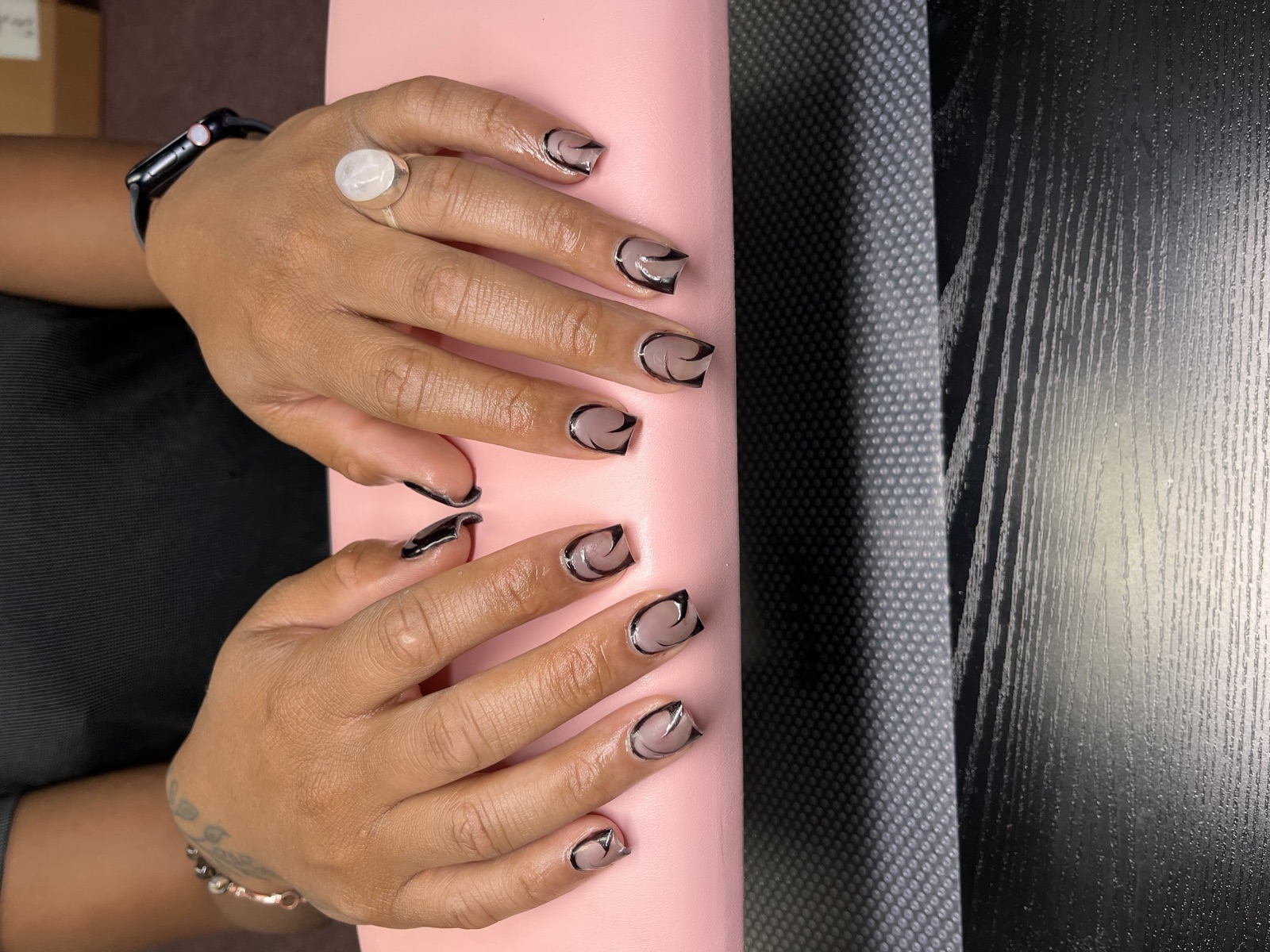 Short nude nail set with black and chrome swirl art